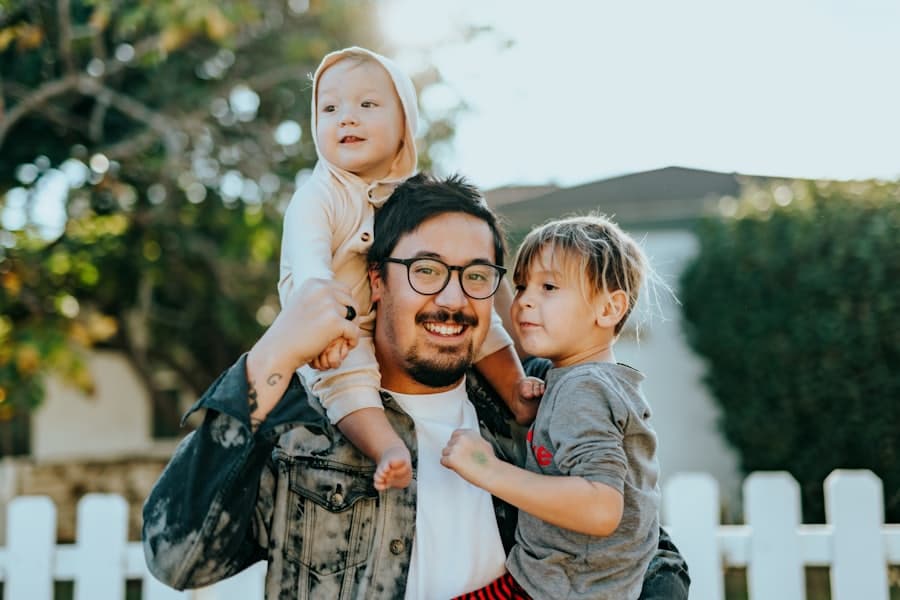 A father smiling with his two young children, reunited as a family